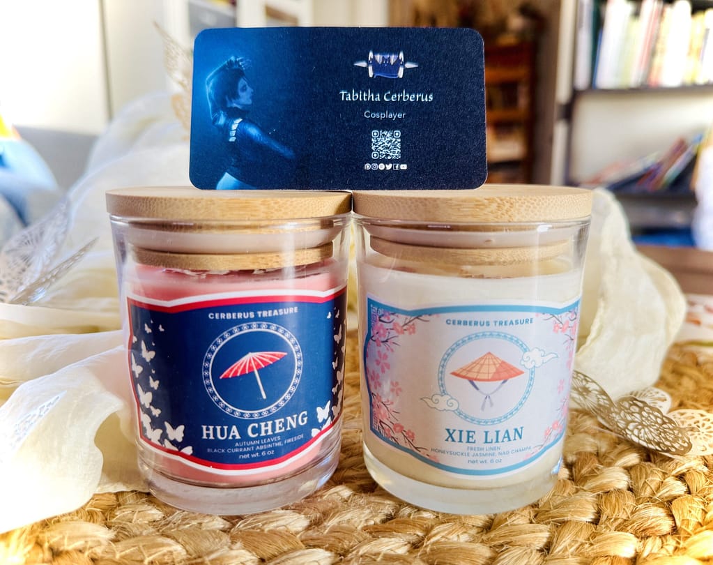 Hua Cheng and Xie Lian candles with maker business card on top